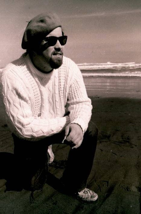 Old photograph of beatnik man wearing beret and sunglasses with white aran knitted jumper