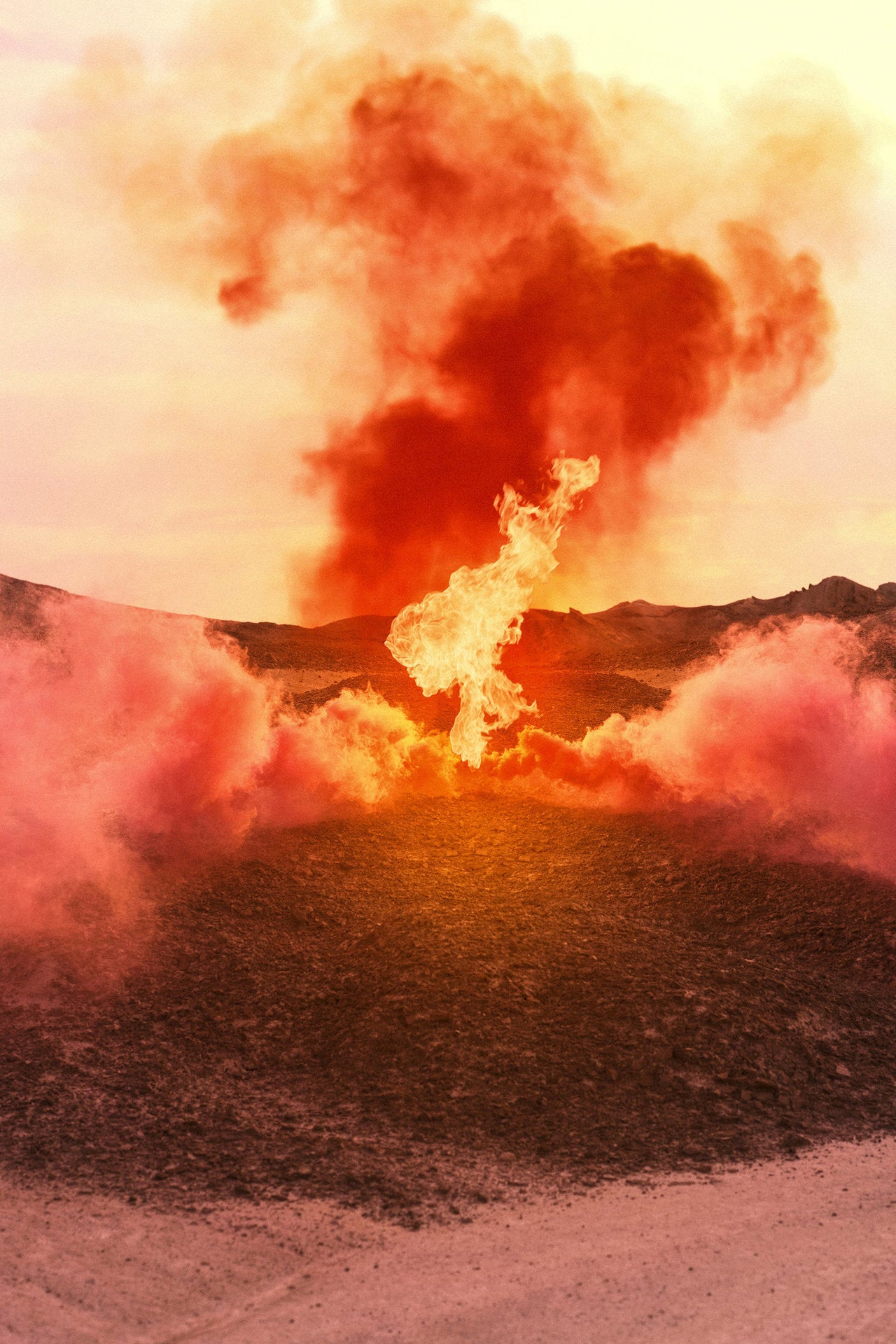 image of large flame on barren landscape and plume of smoke