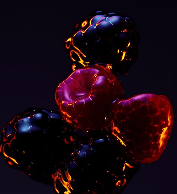 Dark photograph of glistening berries by Romain Lenacker