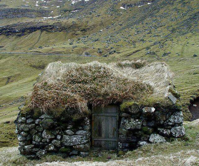 ancient hut in Scottish highlands with mossy roof