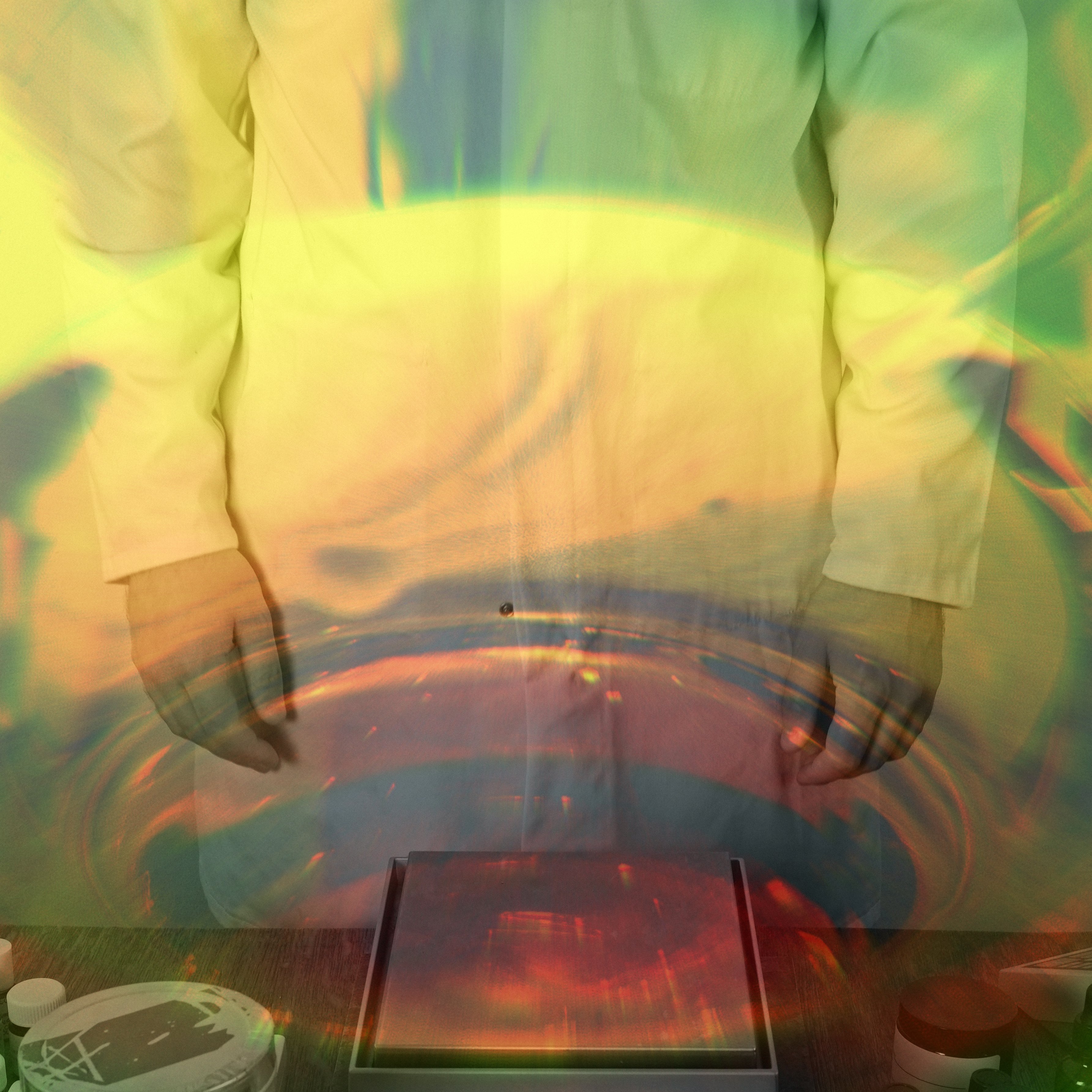 Perfumer in white lab coat overlaid with abstract image of whisky glass