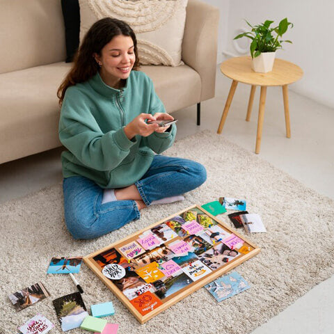 Create a female taking a photo of her vision board