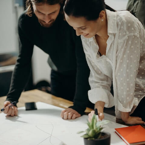 Creative colleagues working in the creative process to outline a design