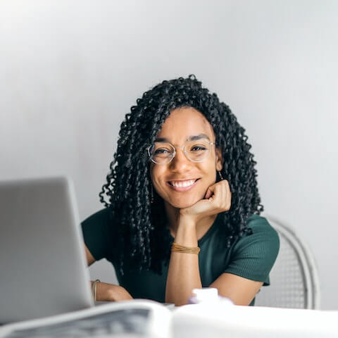 Creative entrepreneur practising self love whilst working at her laptop