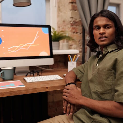 Creative entrepreneur sat in front of MacBook Pro