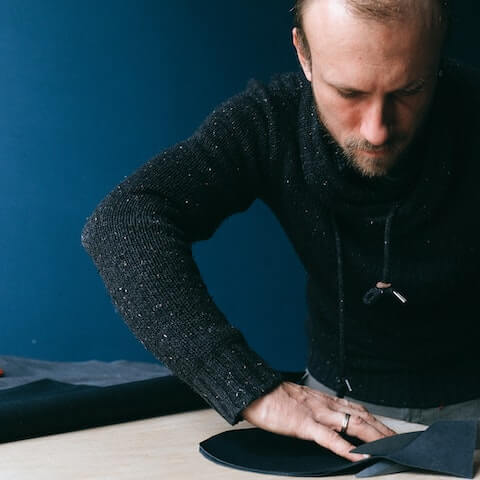 Creative entrepreneurur working cutting fabric