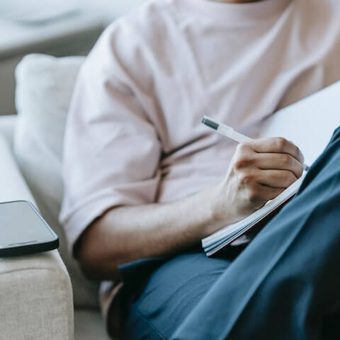 Entrepreneur writing in his journal