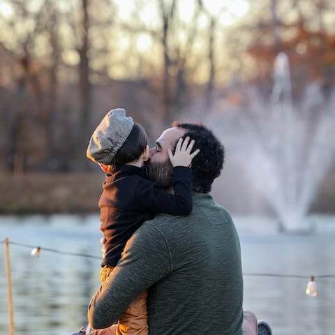 Father_kissing_his_son_by_a_lake