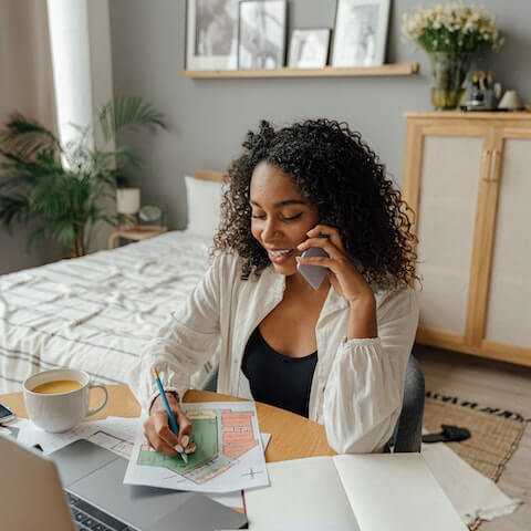 Female, creative entrepreneur multitasking on the phone
