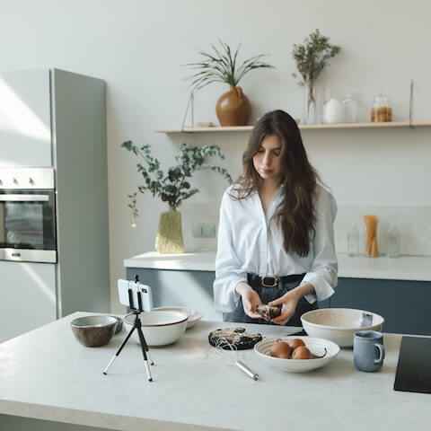 Female digital entrepreneur making videos about food preparation
