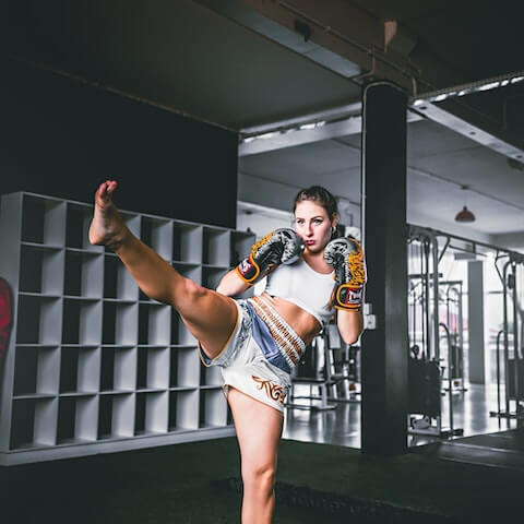 Female founder practising kickboxing to boost productivity