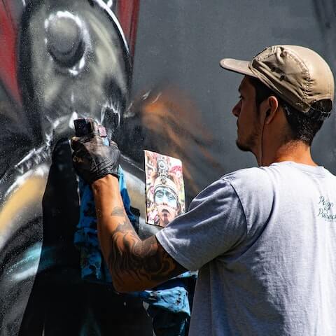 Graffiti artist using his creative mindset to paint