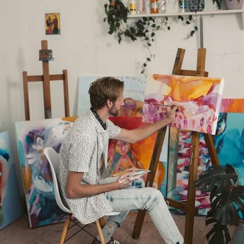Male artist using his creative mindset to paint