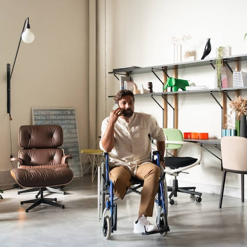 Male creative entrepreneur on the phone sat in his wheelchair