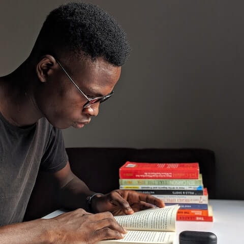 Male creative entrepreneur reading a book