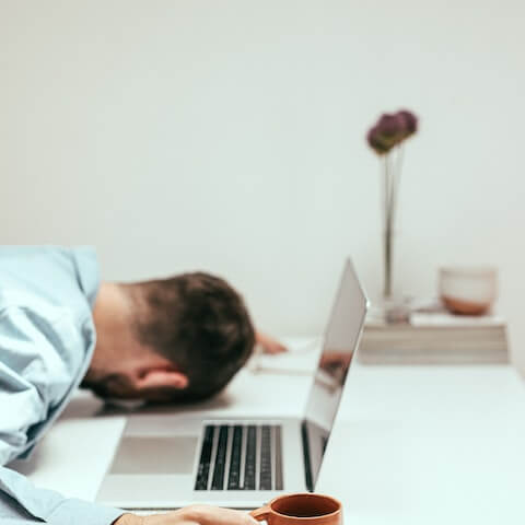 creative man sleeping at his desk battling burnout
