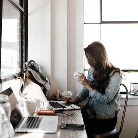 lady working at desk on mac