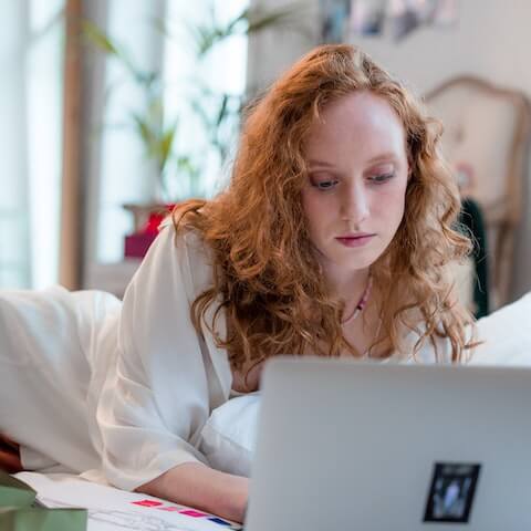 lady working in bed having a productive day