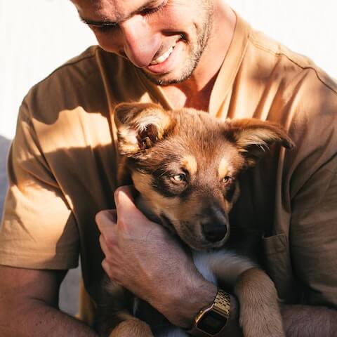male entrepreneur focusing on his wellbeing loving his dog