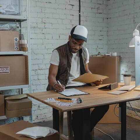 creative entrepreneur fulfilling orders in warehouse