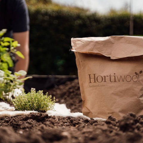 The Hortiwool Pouch being used on an allotment