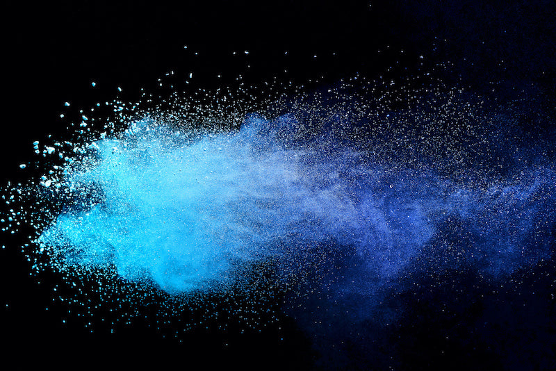 A blue powder explosion on a black background
