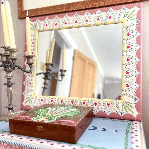Detailed framed mirror on dresser