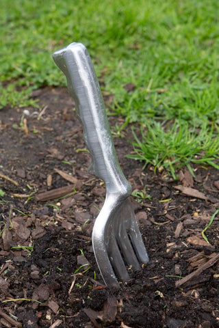 A garden fork in the dirt