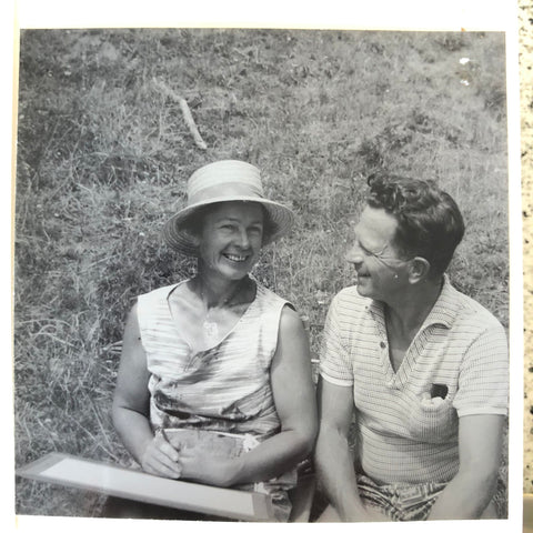 black and white photo of a married couple smiling the woman holds an art board and wears a boater hat the man wears a collared polo shirt 1962 new zealand macbeath