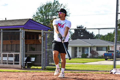 a baseball playing wearing Torege baseball sunglasses playing baseball in action