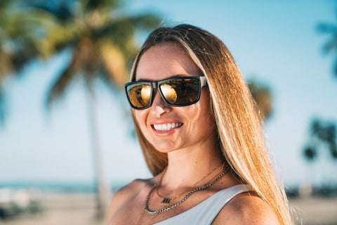 a woman wearing Torege UV-resistant sunglasses in sunny summer outdoor setting