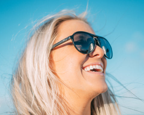 a woman wearing Torege Aviator sunglasses smiling