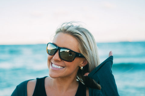 a woman wearing Torege brown lens polarized sunglasses outdoors