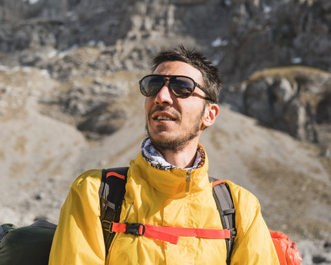 a man hiking in the mountain wearing Torege aviator sunglasses