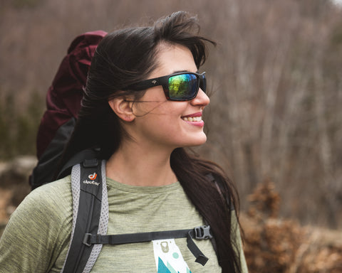 a girl hiking wearing polarized sunglasses