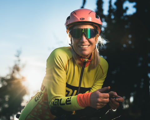 a cycling woman wearing the Torege Ethereal sunglasses model