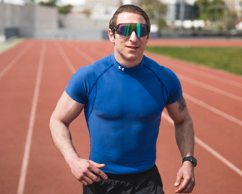 an athlete running on the track wearing Torege running sunglasses