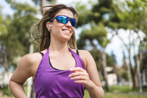 a woman running outdoors wearing Torege sports sunglasses