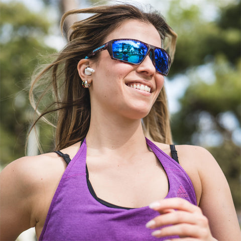 a woman running wearing Torege running sunglasses