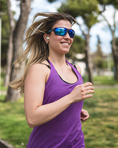 a woman running in outdoor setting wearing Torege running sunglasses