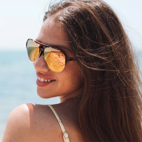 a woman enjoying the beach wearing Torege aviator sunglasses