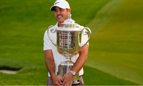 Brooks Koepka holding the 2023 PGA championship trophy