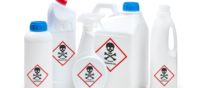 Assorted white bottles marked toxic chemicals