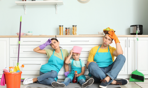 Family sitting kitchen floor exhausted from cleaning with chemicals