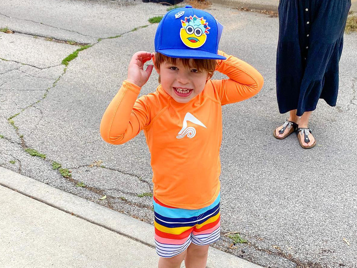 Little boy smiling with a 3D Xpressions hat on