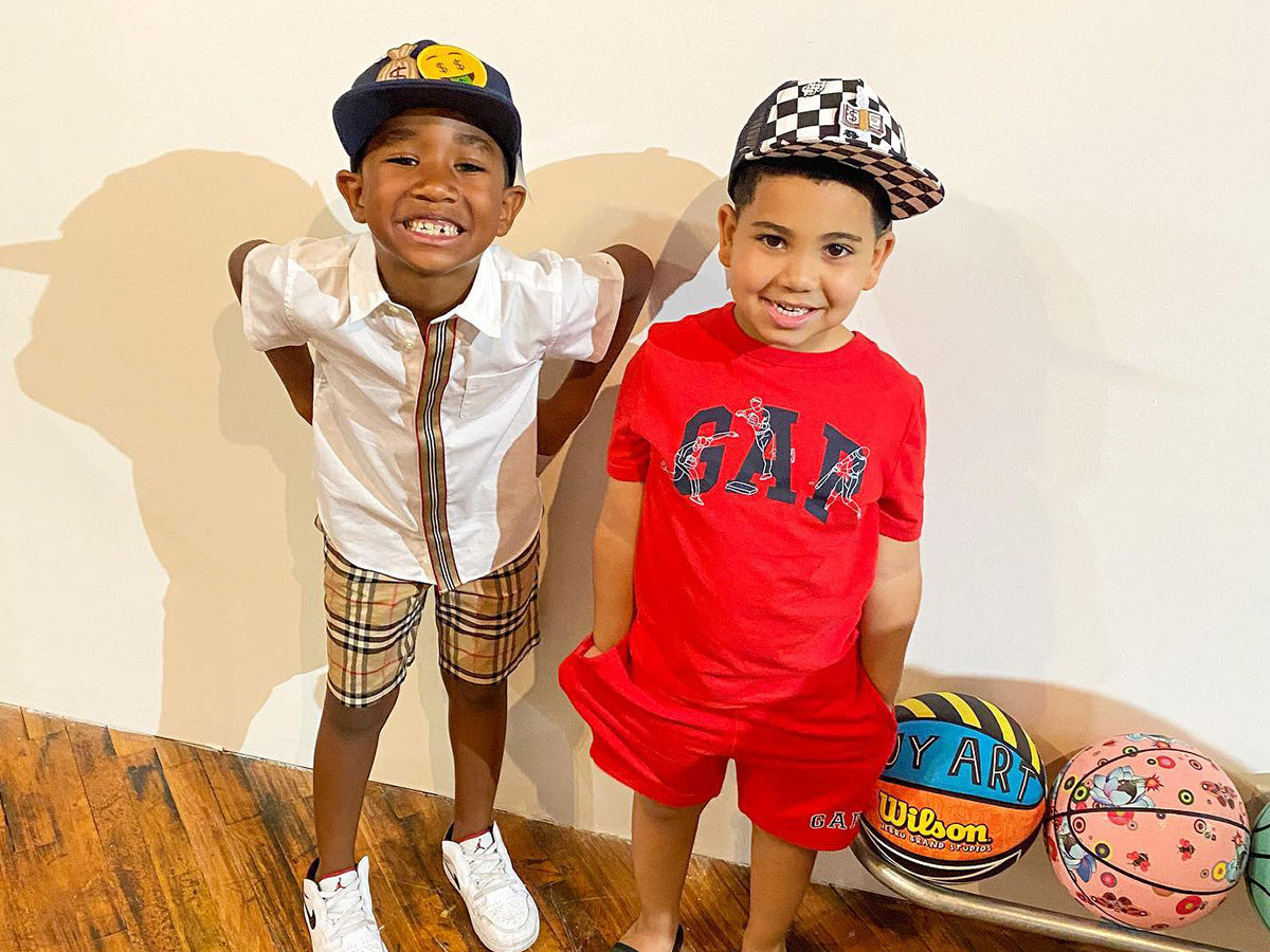 two children wearing fashionable hats