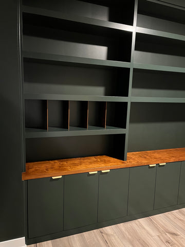 Dark green shelving unit and cabinetry with slots for vinyl record storage for home office