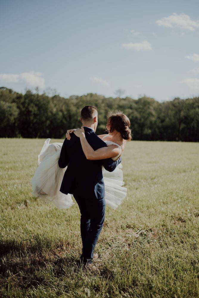 A groom carrying his bride