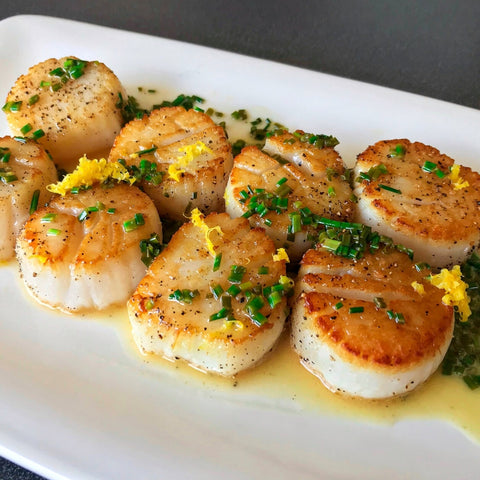 seared scallops topped with lemon herb butter sauce