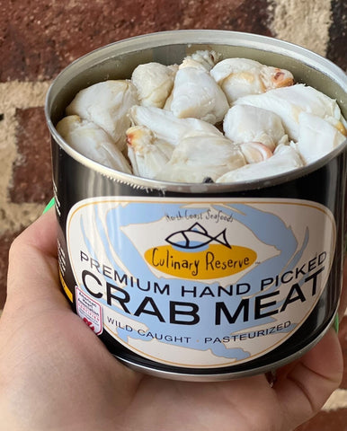 hand holding a can of culinary reserve crab meat